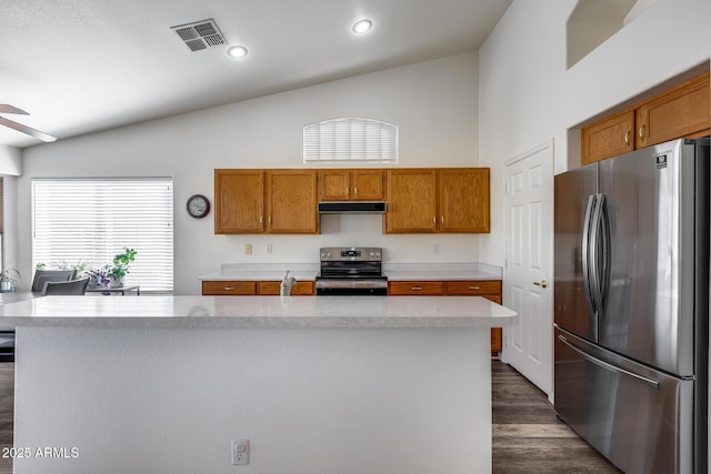 kitchen with stainless steel appliances, brown cabinets, visible vents, and under cabinet range hood