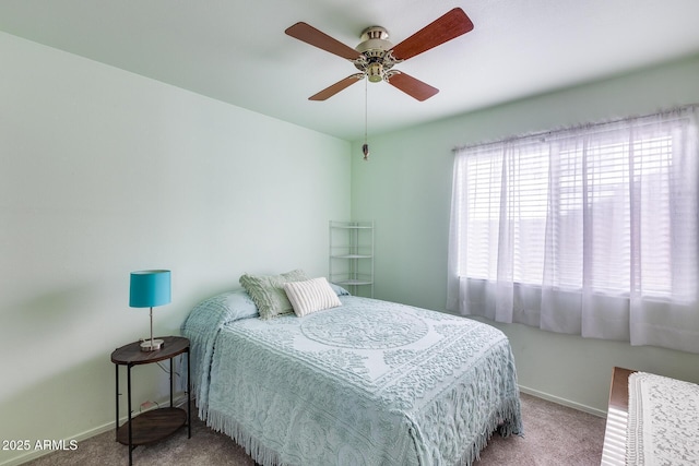 bedroom with ceiling fan, carpet flooring, and baseboards