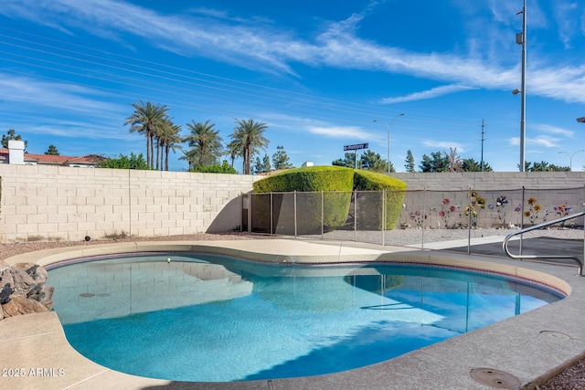 view of swimming pool with a fenced backyard and a fenced in pool