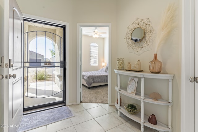 entrance foyer with baseboards and light tile patterned floors