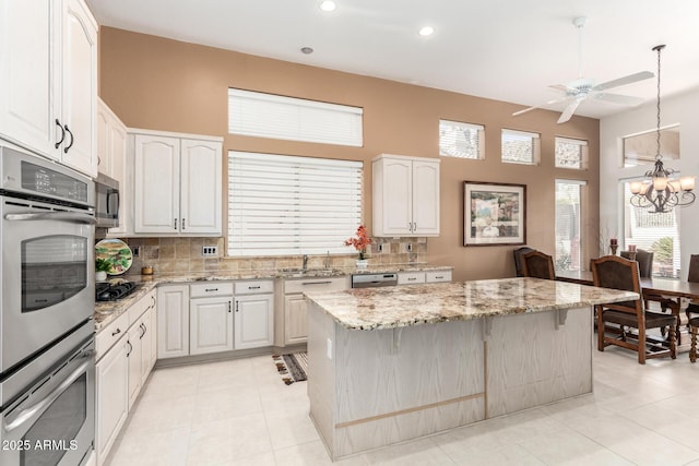 kitchen featuring white cabinetry, a center island, and tasteful backsplash