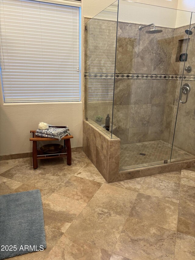 bathroom with a shower with door