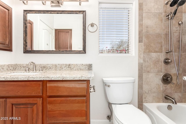 full bathroom featuring toilet, tiled shower / bath combo, and vanity