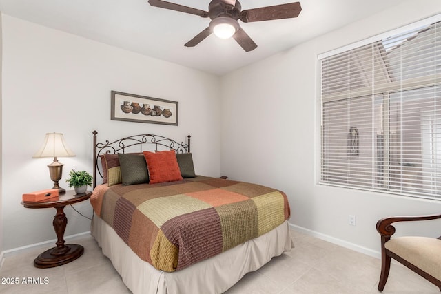 tiled bedroom featuring ceiling fan