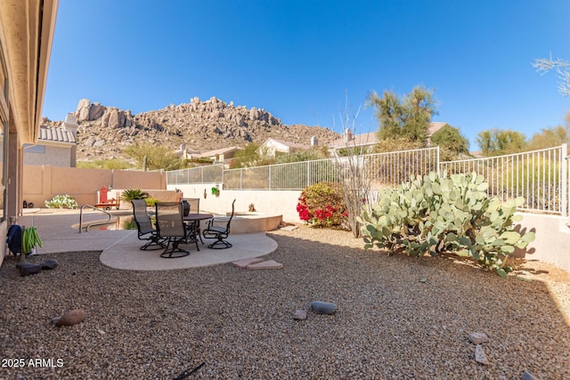 view of yard featuring a patio area and a mountain view