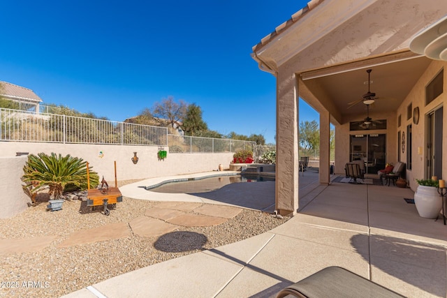 view of patio / terrace with ceiling fan and a fenced in pool