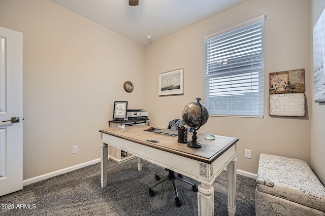 office space with ceiling fan and dark colored carpet