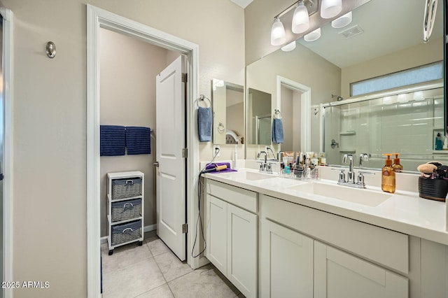 bathroom featuring vanity, a shower with shower door, and tile patterned floors