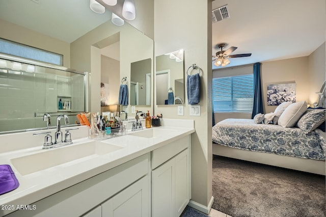 bathroom with walk in shower, ceiling fan, and vanity