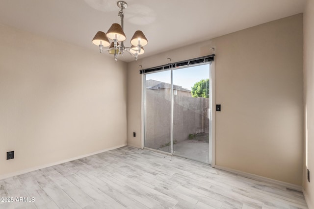 6902 W Devonshire Ave Unit 1280, Phoenix, AZ 85033 - interior space featuring baseboards, light wood-style flooring, a notable chandelier, and access to exterior