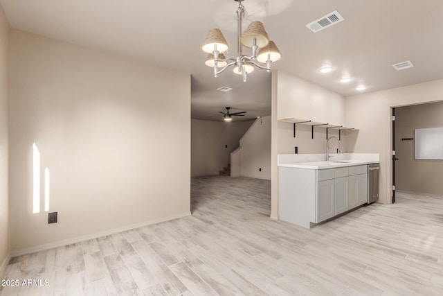 6902 W Devonshire Ave Unit 1280, Phoenix, AZ 85033 - kitchen with stainless steel dishwasher, light wood-style floors, visible vents, and light countertops