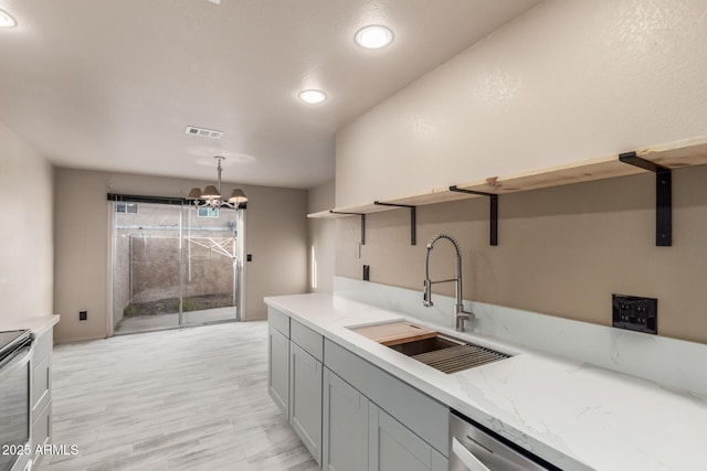 6902 W Devonshire Ave Unit 1280, Phoenix, AZ 85033 - kitchen with visible vents, open shelves, light stone countertops, a sink, and a chandelier