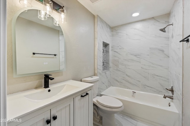 full bathroom with vanity, toilet, and tiled shower / bath