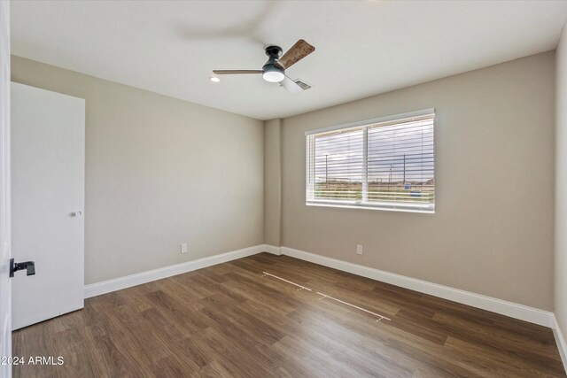 spare room with ceiling fan and dark hardwood / wood-style flooring