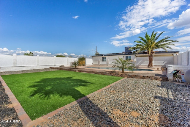 view of yard with a patio and a fenced in pool