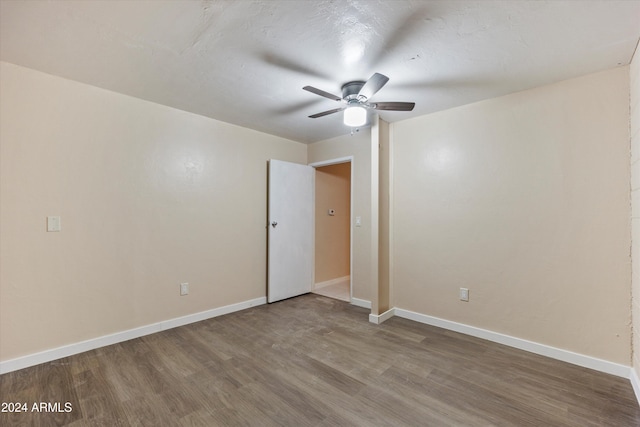 spare room featuring wood-type flooring and ceiling fan