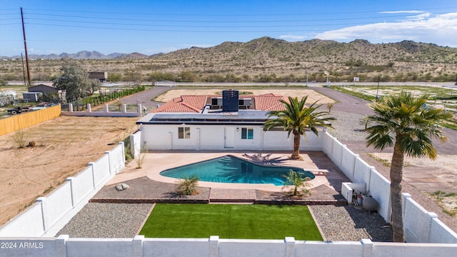 view of swimming pool featuring a mountain view and a patio area