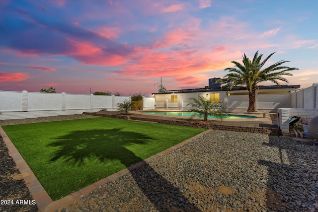 yard at dusk with a patio and a fenced in pool