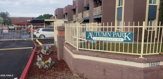 community sign with fence