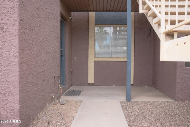view of exterior entry with stucco siding