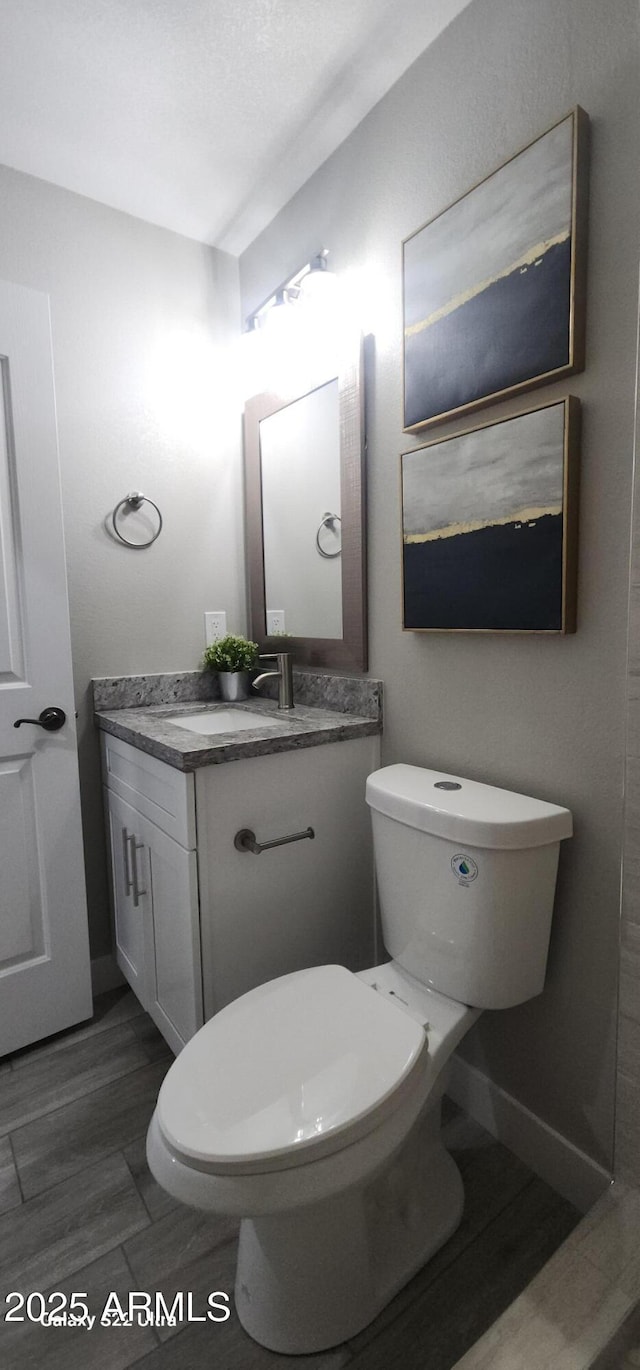 329 W Fairhaven Rd, Kearny, AZ 85137 - half bath featuring vanity, toilet, baseboards, and wood finished floors