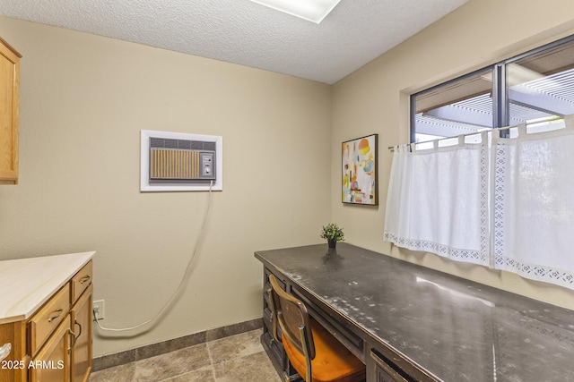 bathroom featuring an AC wall unit and a textured ceiling