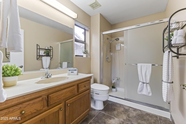 bathroom with vanity, toilet, and a shower with shower door