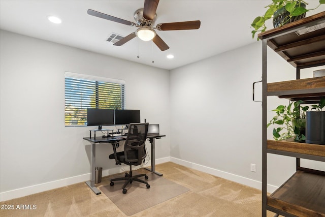 office space featuring light carpet and ceiling fan