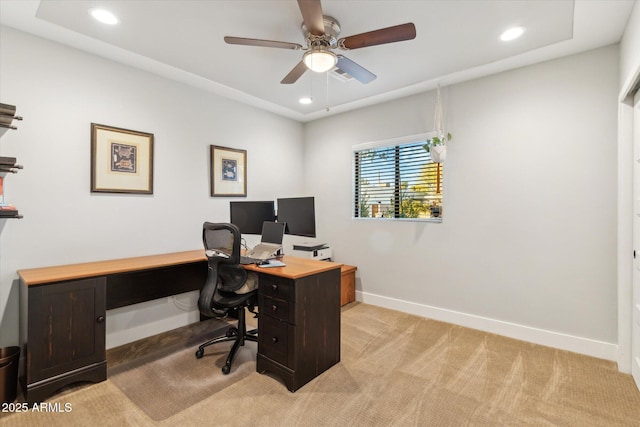 carpeted office space with ceiling fan