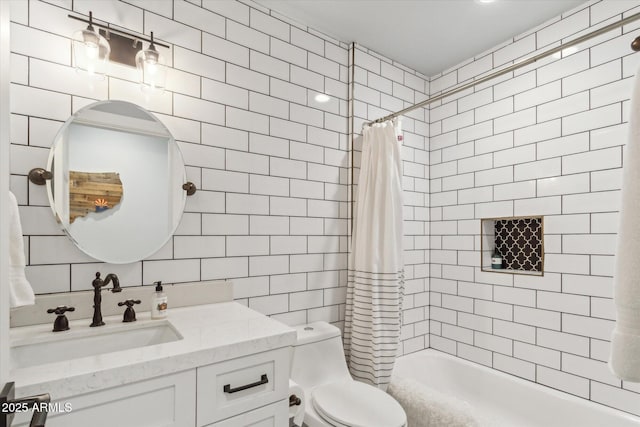 full bathroom featuring tile walls, backsplash, vanity, shower / tub combo, and toilet