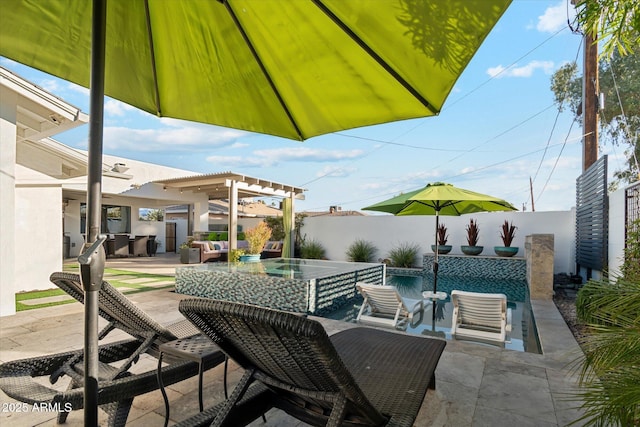 view of patio / terrace featuring a pool with hot tub