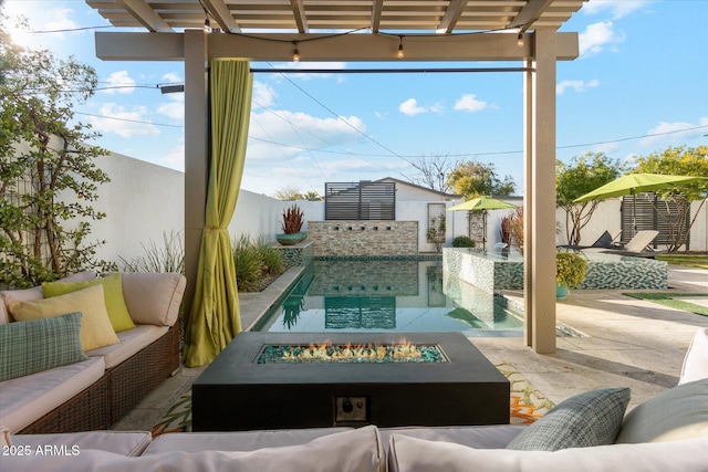 view of patio with an outdoor living space with a fire pit