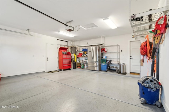 garage with a garage door opener and stainless steel fridge