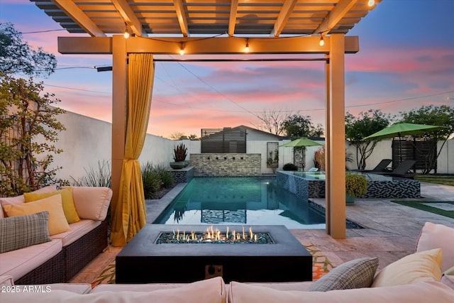 pool at dusk featuring a pergola, an outdoor living space with a fire pit, and a patio area