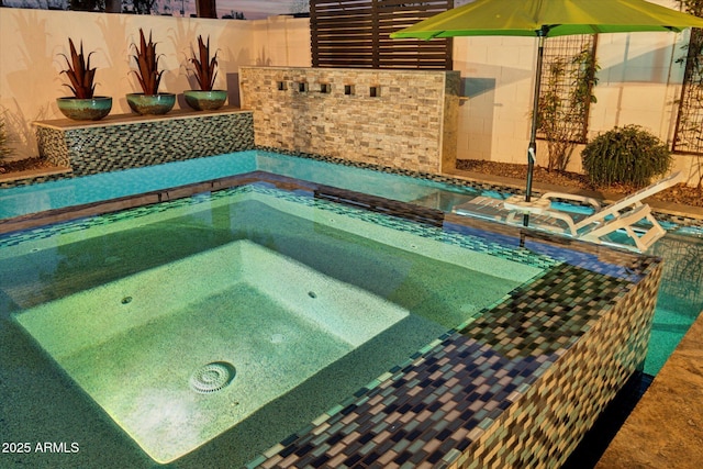 view of swimming pool with an in ground hot tub