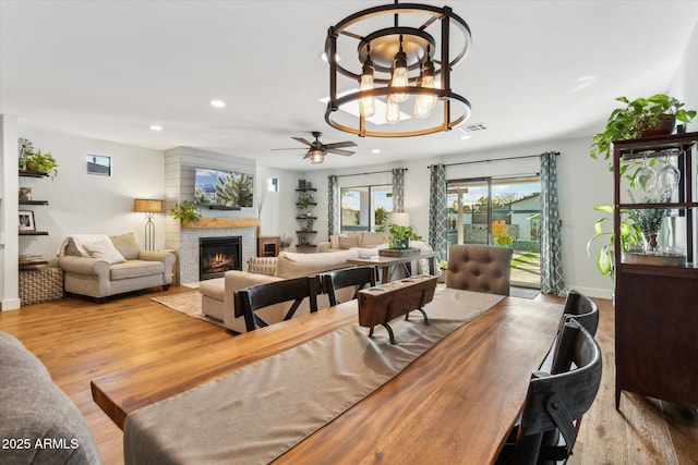 living room with a fireplace and light wood-type flooring