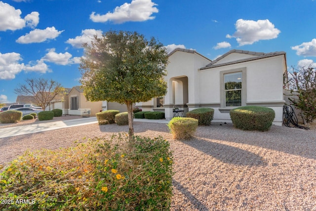 view of front of house with a tiled roof and stucco siding