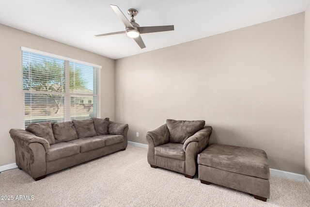 living area featuring carpet flooring, a ceiling fan, and baseboards