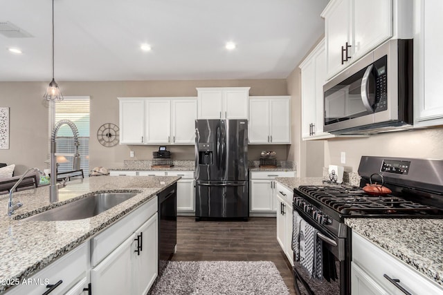 kitchen featuring a sink, visible vents, white cabinets, black appliances, and dark wood finished floors