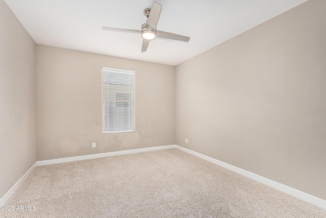 carpeted empty room featuring a ceiling fan and baseboards