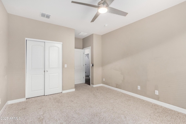 unfurnished bedroom with baseboards, visible vents, ceiling fan, carpet floors, and a closet