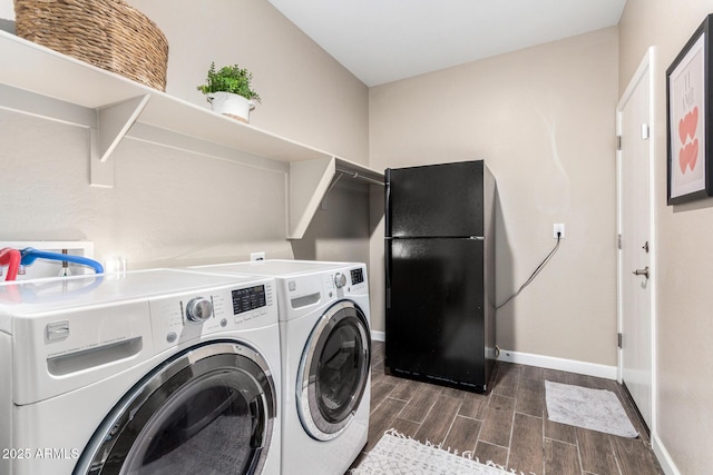 laundry area featuring washer and dryer, laundry area, baseboards, and wood tiled floor