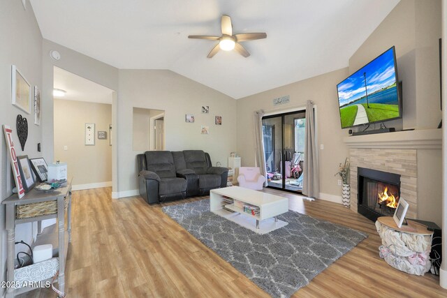 15050 N Thompson Peak Pkwy Unit 2072, Scottsdale, AZ 85260 - living area featuring wood finished floors, ceiling fan, vaulted ceiling, a fireplace, and baseboards