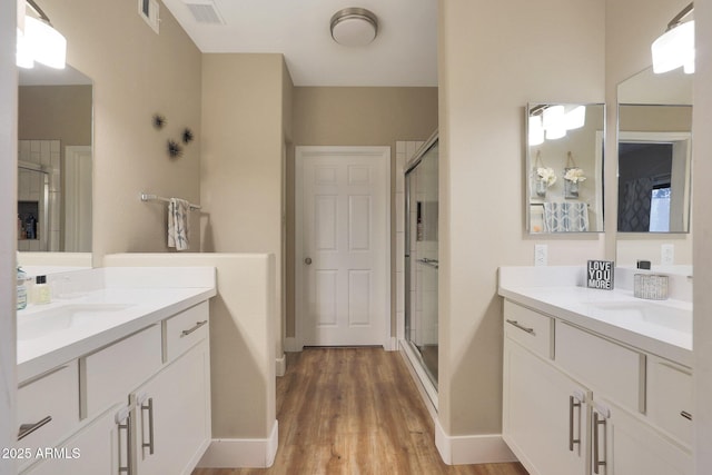 15050 N Thompson Peak Pkwy Unit 2072, Scottsdale, AZ 85260 - full bathroom with a shower stall, two vanities, and wood finished floors