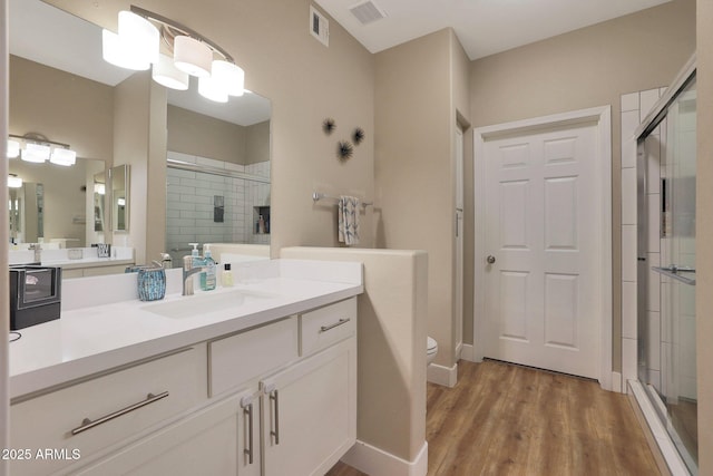 15050 N Thompson Peak Pkwy Unit 2072, Scottsdale, AZ 85260 - full bath with a shower stall, vanity, wood finished floors, and toilet