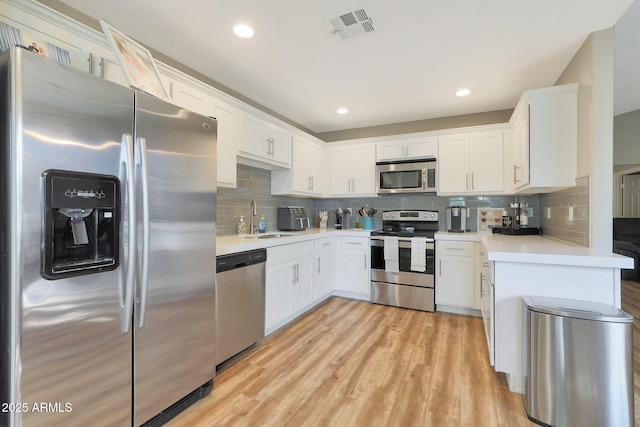 15050 N Thompson Peak Pkwy Unit 2072, Scottsdale, AZ 85260 - kitchen featuring appliances with stainless steel finishes, a sink, backsplash, white cabinets, and light countertops