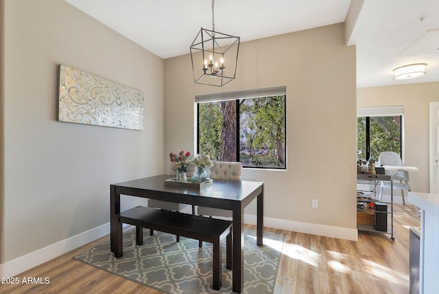 15050 N Thompson Peak Pkwy Unit 2072, Scottsdale, AZ 85260 - dining room featuring a chandelier, light wood-type flooring, and baseboards