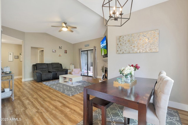 15050 N Thompson Peak Pkwy Unit 2072, Scottsdale, AZ 85260 - dining space with lofted ceiling, wood finished floors, ceiling fan, baseboards, and a chandelier