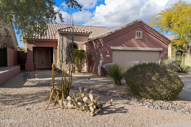 mediterranean / spanish-style home with a garage