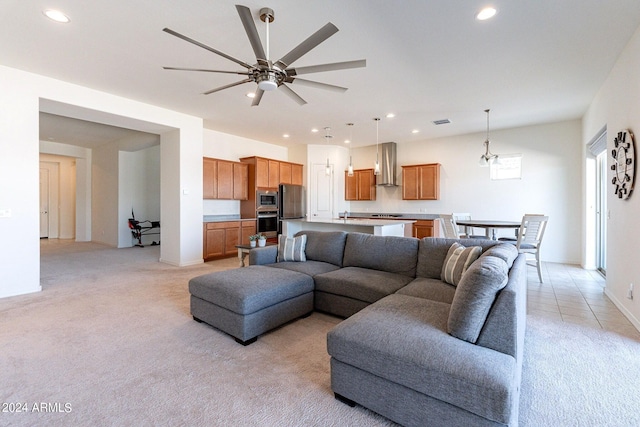 living room featuring ceiling fan and light colored carpet